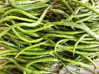 Green pepper or chili from the farm, Close up or macro fresh beautiful Green peppers on the market texture and background, a lot of chili on basket for trader and business and establishment