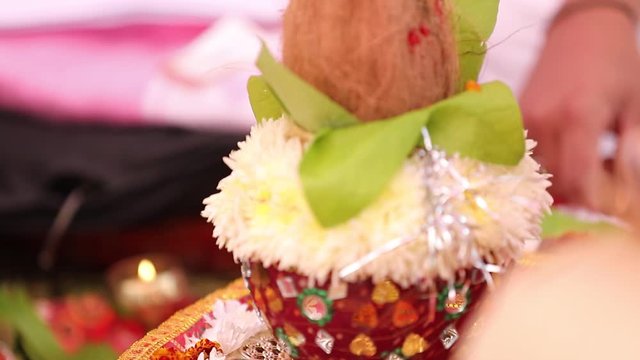 Indian wedding ceremony : decorative coper kalash with green leaf and coconut 