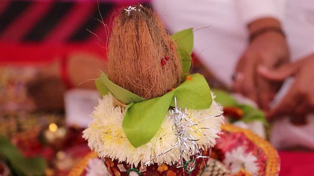 Indian wedding ceremony : decorative coper kalash with green leaf and coconut 