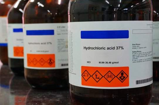 Bottle of Hydrochloric Acid, HCL with Properties information and its chemical hazard warning symbols. Corrosive, Inhalation,Toxic warning, Hazardous to the Environment.