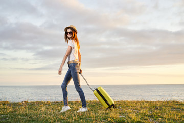 girl with suitcase on road