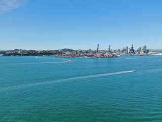 Obraz na płótnie Canvas Devonport, Auckland / New Zealand - December 11, 2019: The Victorian Style Seaside Village of Devonport, with the skyline of Auckland’s landmarks and CBD in the background
