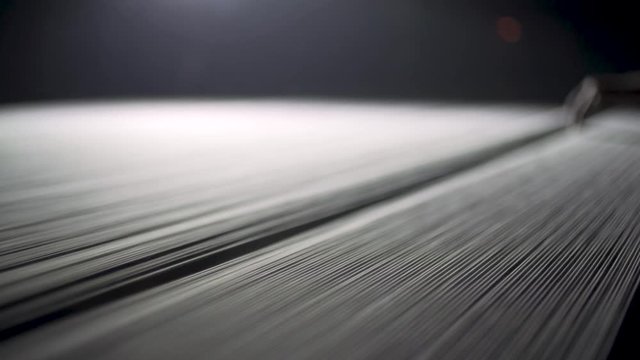 Closeup Of Denim Textile Thread Being Warped During Manufacturing.