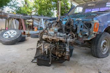 The Old Car engine on crane hook in garage repair service, outdoor.