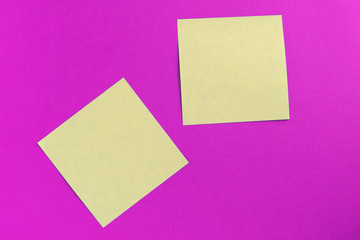 Obraz na płótnie Canvas Two square sticker notes on a bright pink background close up