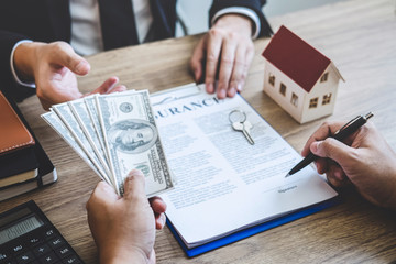 Estate agent broker receive money from client after signing agreement contract real estate with approved mortgage application form, buying or concerning mortgage loan offer for and house insurance