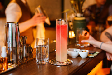 A refreshing low-abv cocktail in a highball glass on the bar counter. Warm lifestyle image, selective focus, natural light