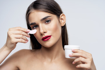 young woman applying makeup