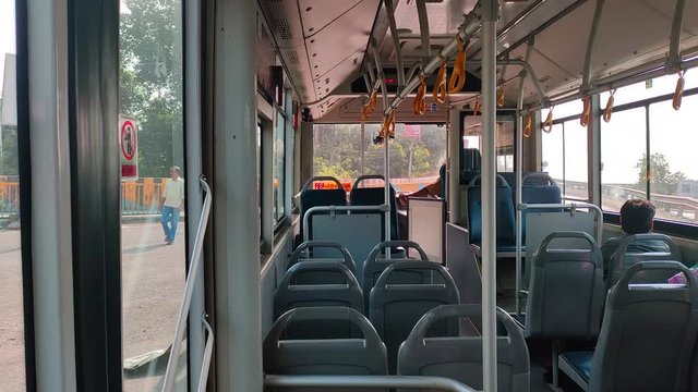 Empty bus turning on signal very few passenger.