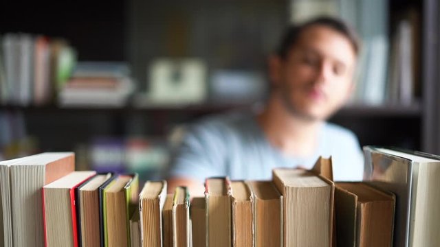 Man selecting books on a shelf