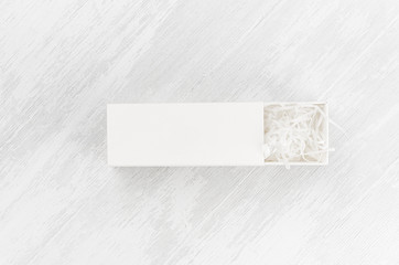 White blank open rectangle box with filler mock up on wood board top view for showing product,...