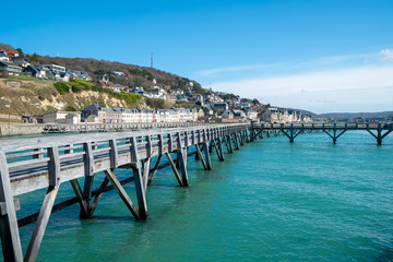 Fototapeta na wymiar View of the walkway on the pier at the entrance of the Port of Fecamp, Seine-Maritime, Normandy, France, Europe on the coast of Normandy in the English Channel in Spring 