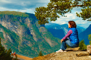Fototapeta na wymiar Tourist enjoying mountains fjord view, Norway