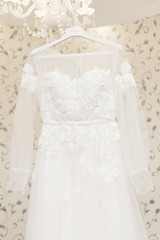 Fototapeta na wymiar wedding dress hanging on the mirror, bride's morning