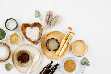 Fototapeta na wymiar Beauty treatment ingredients for making homemade skin care cosmetic mask. Various bowl with clay, cream, essential oil and natural ingredients on white table background. Organic spa cosmetic products