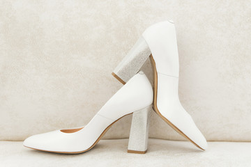 The details of the wedding day. Bride's shoes on a light background