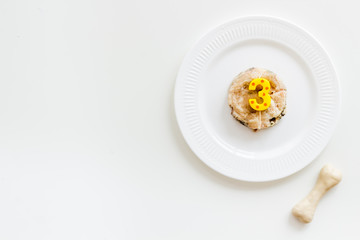 Birthday party for puppy concept. Dog feed, candle in shape of number three, bones on white background top-down copy space