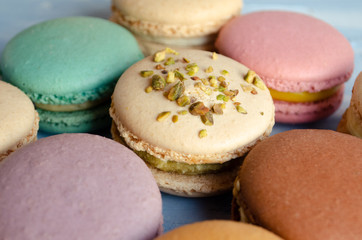  Multi-colored macarons on a blue texture background. 