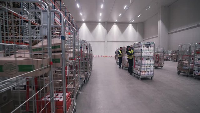workers move goods in warehouse