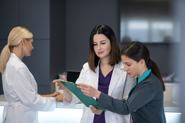 Three beautiful female doctors dicussing the xray