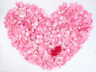 Heart symbol made of pink rose petals.