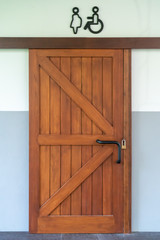 Brown wooden door locked with handicapped sign