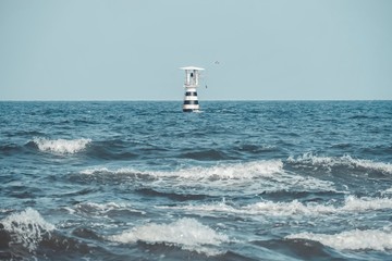 Lighthouse on the sea with Thailand flag.