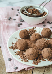 Home made chocolate truffles in a white dish. Food home cooking concept.