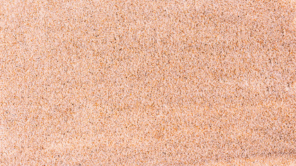 Amazing fine sea sand from the ocean. Sand texture background. Banner. Selective focus. Top view.