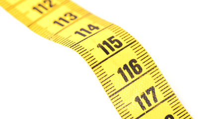 Close-up of a yellow measuring tape isolated on white - 116