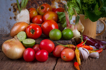 Mixed fruits and vegetables on old wood table background