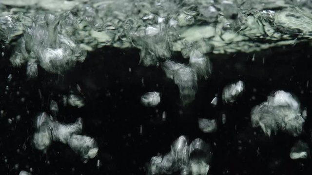 Boiling Water With Air Bubbles Close Up. Black Background