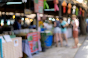 Abstract Blurred image of Chiangmai street market with bokeh for background usage.