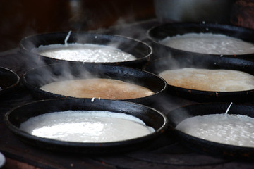 Rural stove. On it in pig-iron frying pans pancakes are fried.