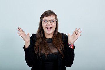 Portrait of scared shocked young woman in casual clothes, rising hands showing palms, smiling...