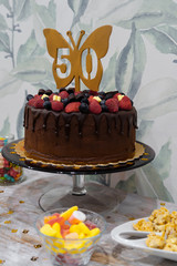 50th birthday cake with chocolate, strawberries and blueberries.