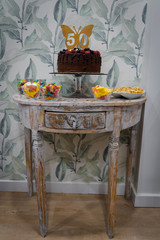 Chocolate cake of 50 birthday presented in vintage table decorated for surprise, celebration, party with gummies, serpentines, confetti, etc..
