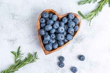 healthy eating antioxidant blueberries in a wooden bowl heart shaped