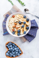 porridge with blueberries banana and nuts top view