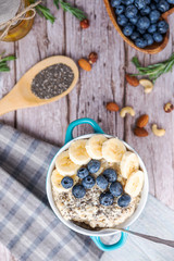 rustic Breakfast oatmeal with berries and banana with Chia seeds top view