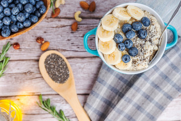 rustic Breakfast oatmeal with berries and banana with Chia seeds top view