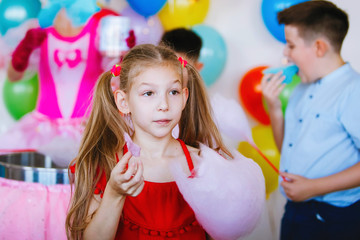 Fototapeta na wymiar Teenager girl with cotton candy at celebration.