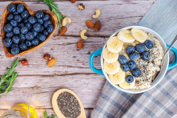 rustic Breakfast oatmeal with berries and banana with Chia seeds top view