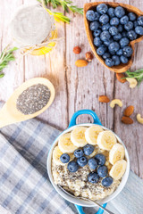 rustic Breakfast oatmeal with berries and banana with Chia seeds top view