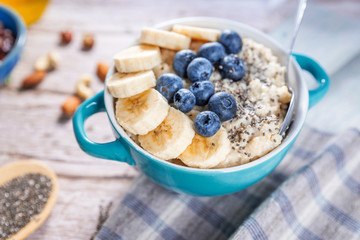 oatmeal with banana and blueberries in a blue bowl