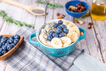 oatmeal with banana and blueberries in a blue bowl