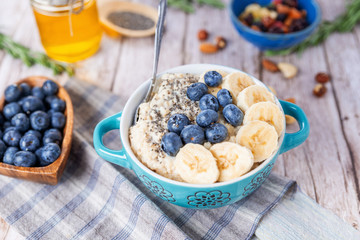 oatmeal with banana and blueberries in a blue bowl