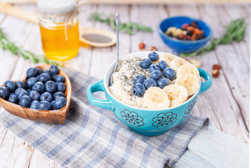 oatmeal with banana and blueberries in a blue bowl