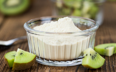 Bowl with fresh made Kiwi powder (selective focus)