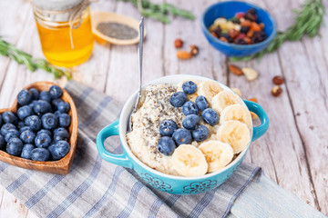oatmeal with banana and blueberries in a blue bowl
